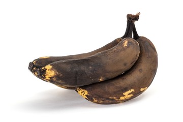 Old overripe bananas on a white background