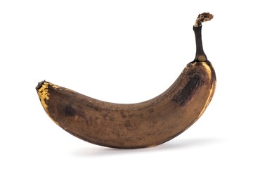 Side view of old overripe banana on white background © JGade