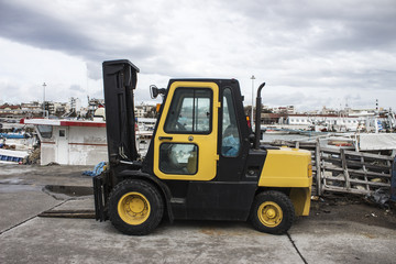 Yellow forklift in harbor