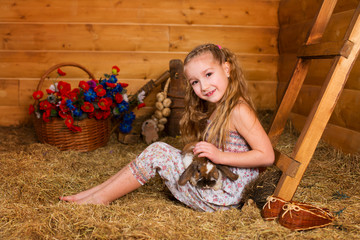 Beautiful happy girl with long blond hair playing with funny eas