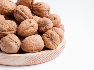 Walnuts on a wooden plate