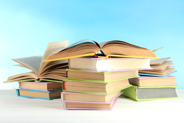 Stacks of books on table on natural background