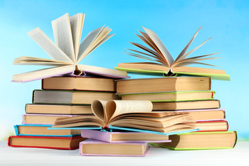 Stacks of books on table on natural background