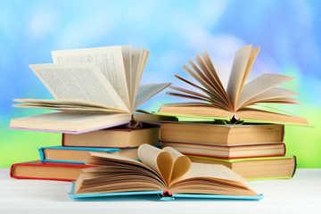 Stacks of books on table on natural background