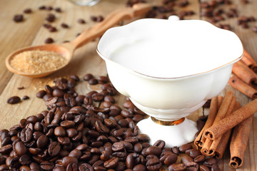 Coffee ingredients. Coffee beans, cinnamon, sugar and milk