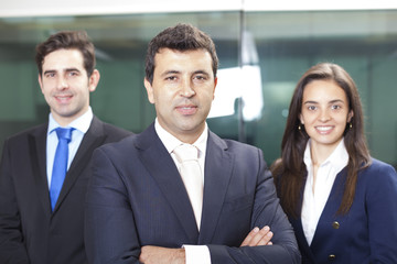 Confident businessman leader on the foreground of his team