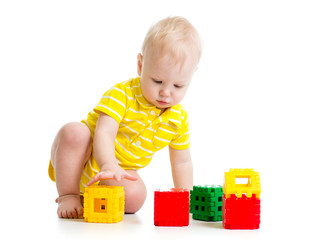 Cute little child is playing with toys