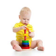 baby boy playing with pyramid toy