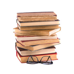 Stack of old antique books and spectacles in thick-rimmed