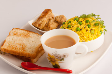 Breakfast- Tea, Poha with bread and Biscuit.