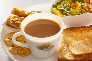 Breakfast- Tea, Poha with bread and Biscuit.