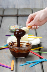 Preparing chocolate dipped banas dessert