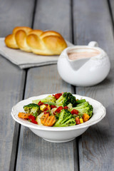 Healthy breakfast: vegetable salad and cream sauce on wood