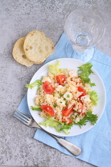 salad with tomatoes, feta cheese, grits and green