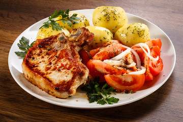 Grilled steak, boiled potatoes and vegetable salad