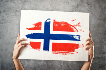 Norway flag. Man holding banner with Norwegian Flag.