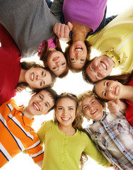 Group of smiling happy teenagers isolated on white