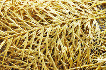 Background of golden plastic leaves