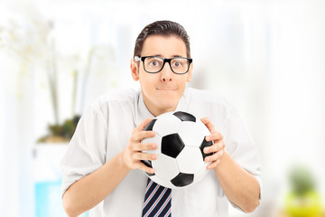 Anxious young sports fan watching football match