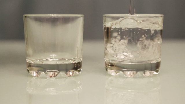 vodka pouring into glasses - close-up