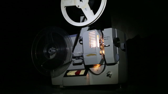 old projector showing film - dolly shot