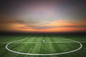 Fototapeta na wymiar Soccer green grass field at sunset