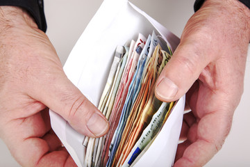 Hands holding envelope with cash