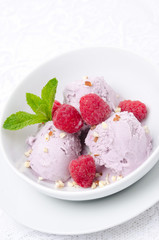 ice cream with fresh raspberries in a bowl close-up vertical