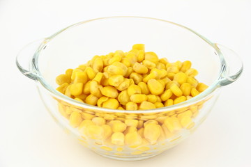 The corn in glass dish on the white background