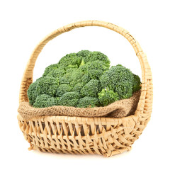 Fototapeta na wymiar Green broccoli in a wicker basket isolated