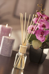 Obraz na płótnie Canvas air freshener sticks at home with flowers and ou of focus backgr