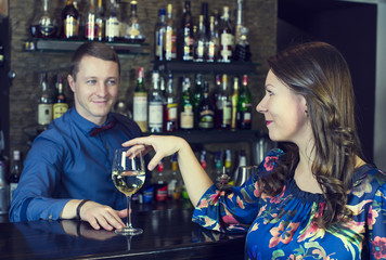 young girl in the bar drinking wine