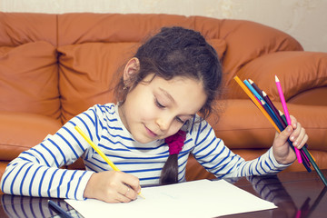children draw with crayons on paper