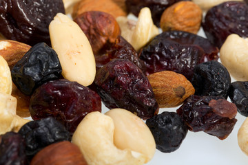 mixed nuts and dried fruits isolated on white background