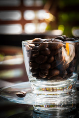 short glass with coffee beans