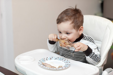 Boy eating duck leg