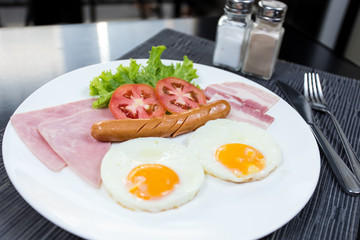 American breakfast with eggs ham bacon and sausage