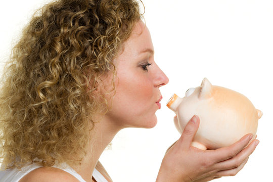 blonde woman kisses piggy bank