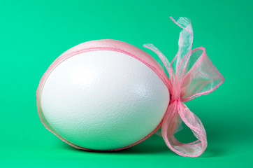 Easter egg with pink ribbon