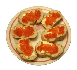 Sandwiches with red caviar on a plate