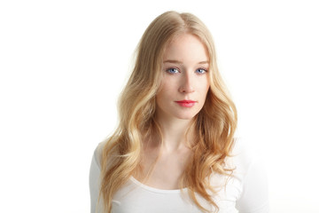Naklejka premium Close-up of a beautiful young woman smiling on white background