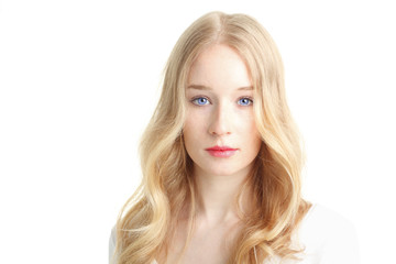 Naklejka premium Close-up of a beautiful young woman smiling on white background