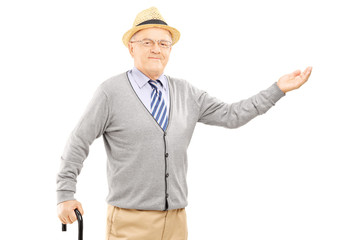 Old man with cane gesturing with hand