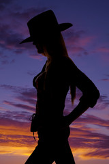beautirul cowgirl silhouette with her hands on her hips