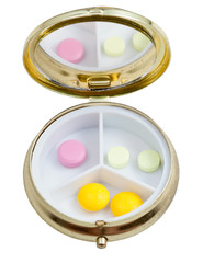 compact pill box with several tablets