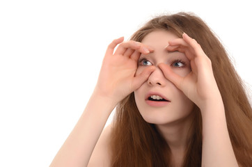 Girl holding the hands at her eyes like a binoculars looking far
