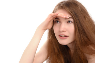 Naklejka premium Young woman holding her hand at the forehead looking far away.
