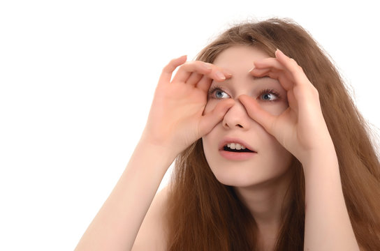 Girl holding the hands at her eyes like a binoculars looking far