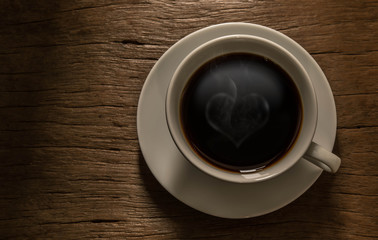 Obraz na płótnie Canvas Coffee with heart shaped smoke and morning light. Shines through
