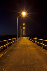 Jetty at sunset with star shaped streetlights